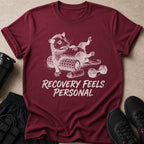 Maroon t-shirt with opossum graphic and text "Recovery Feels Personal."