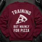 Maroon sweatshirt with white text "TRAINING BUT MAINLY FOR PIZZA" and a pizza slice graphic.