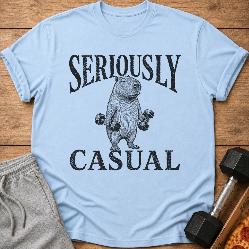 Light blue t-shirt with black text "SERIOUSLY CASUAL" and a drawing of a capybara holding dumbbells.