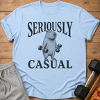 Light blue t-shirt with black text "SERIOUSLY CASUAL" and a drawing of a capybara holding dumbbells.