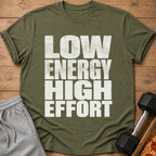 Olive t-shirt with white text "LOW ENERGY HIGH EFFORT" next to sweatpants and a dumbbell.