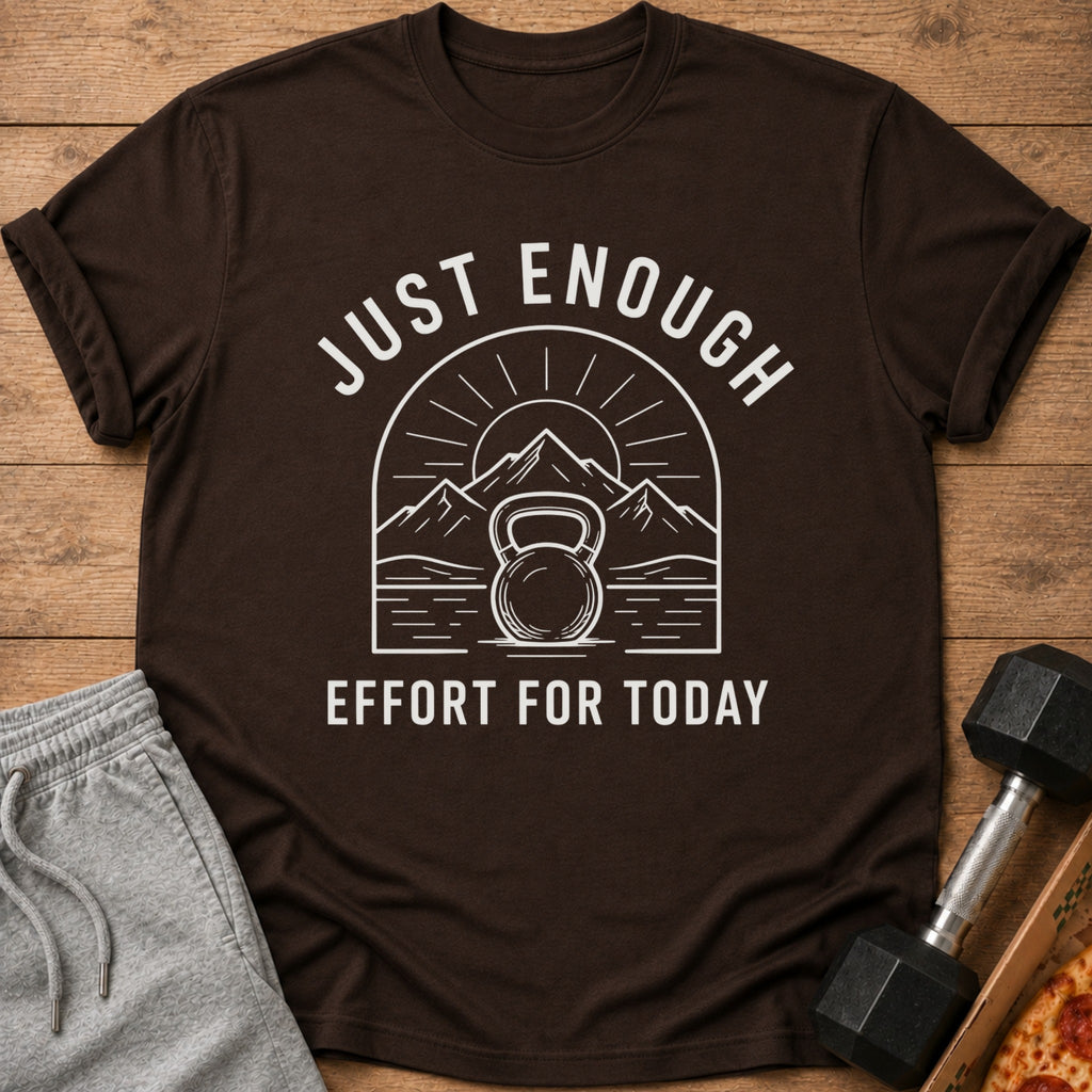 Brown t-shirt with white text and graphic of kettlebell, mountains, and sun.