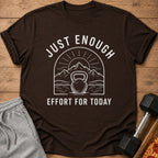 Brown t-shirt with white text and graphic of kettlebell, mountains, and sun.