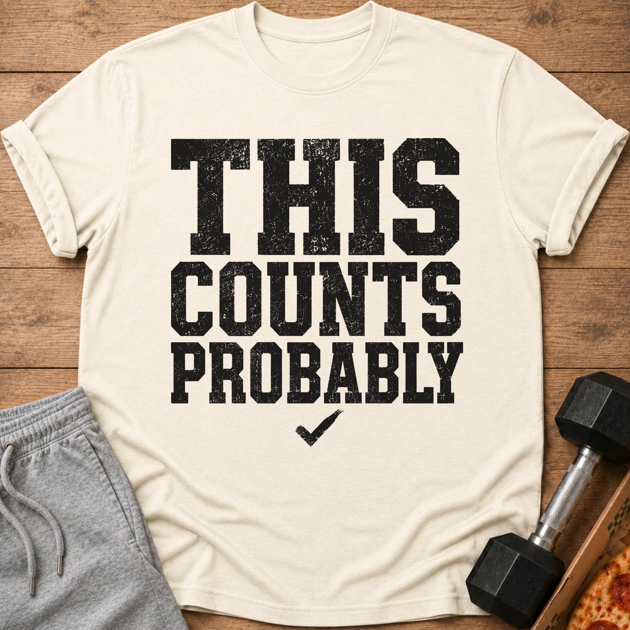 Cream t-shirt with black text "THIS COUNTS PROBABLY" and a checkmark.