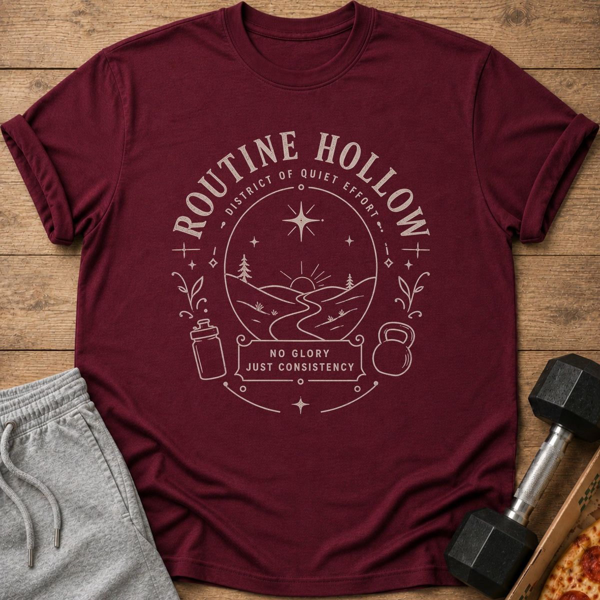 Maroon t-shirt with a circular graphic featuring "ROUTINE HOLLOW" and "NO GLORY JUST CONSISTENCY."