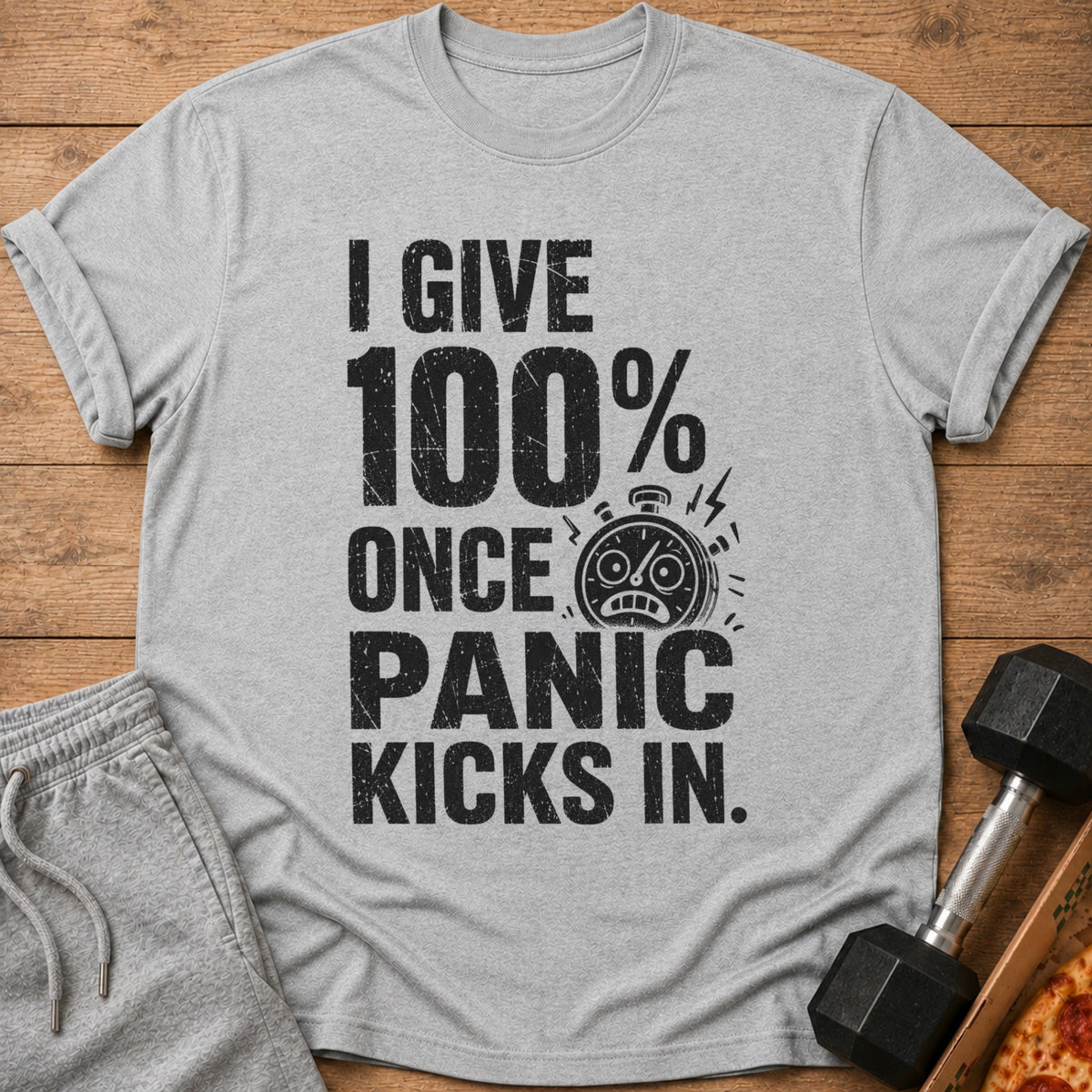 Gray t-shirt with text "I GIVE 100% ONCE PANIC KICKS IN." and stopwatch icon.