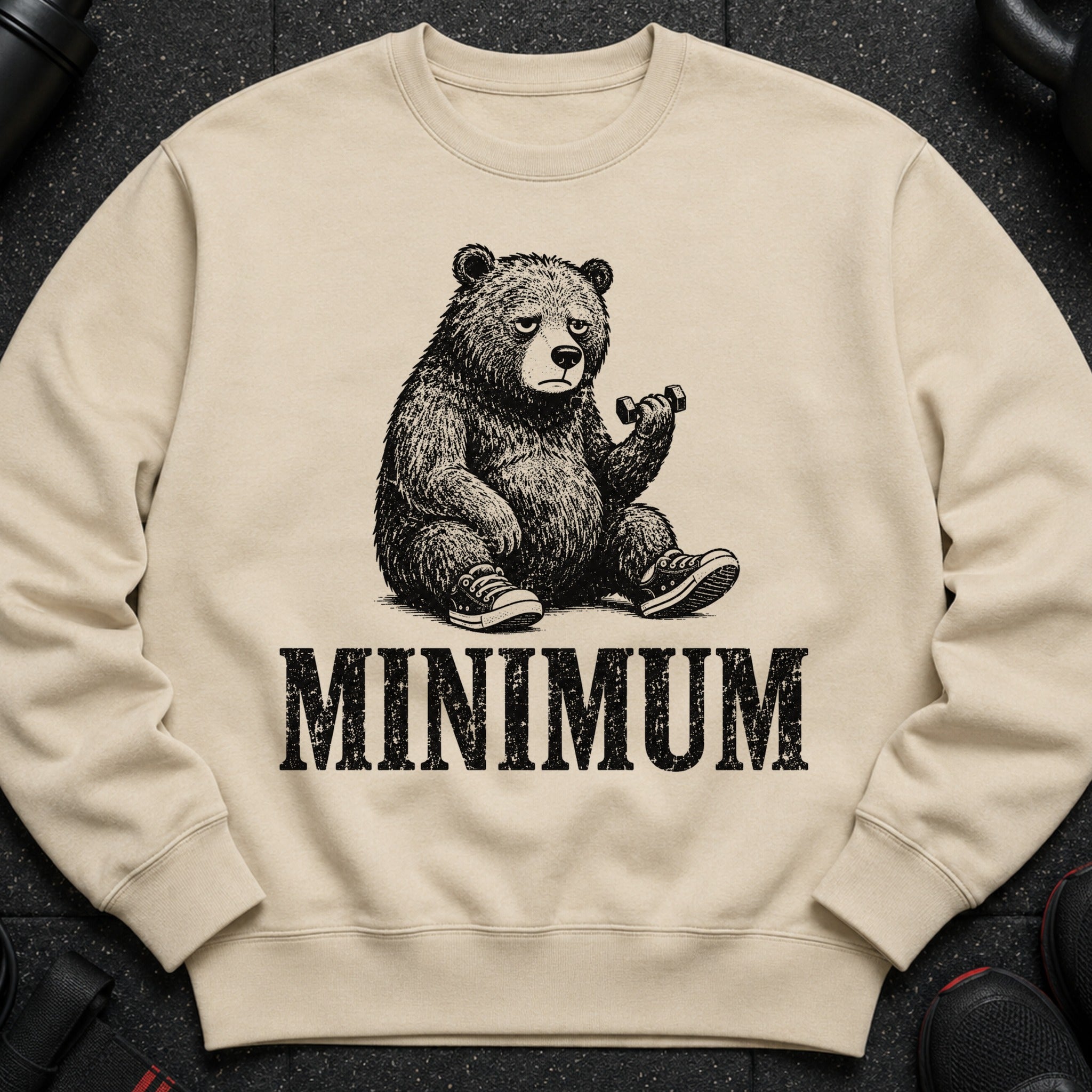 Beige sweatshirt with a distressed print of a bear lifting a dumbbell and the word "MINIMUM".