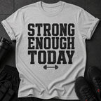 Grey t-shirt with black distressed text "STRONG ENOUGH TODAY" and a barbell graphic.