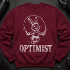 Maroon sweatshirt with a jumping rabbit graphic and the word OPTIMIST.