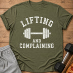 Olive green t-shirt with white text "LIFTING AND COMPLAINING" and a dumbbell graphic.