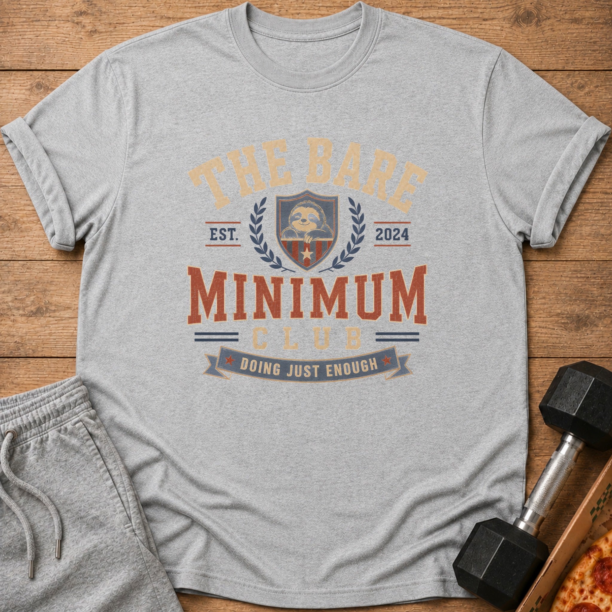 Grey t-shirt with "The Bare Minimum Club" and sloth design, est. 2024.