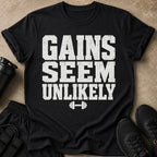 Black t-shirt with white text "GAINS SEEM UNLIKELY" and dumbbell graphic.