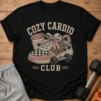 Black t-shirt with "Cozy Cardio Club" graphic featuring a sneaker, coffee cup, and dumbbell.