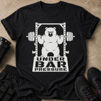Black t-shirt with white graphic of a bear lifting weights, text reads "UNDER BAR PRESSURE."
