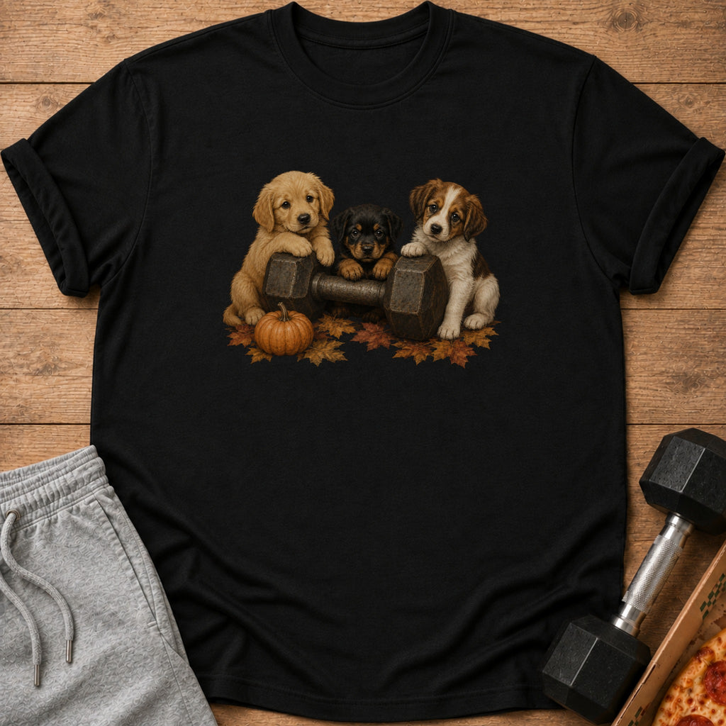 Three puppies sit behind a dumbbell with autumn leaves and a pumpkin.