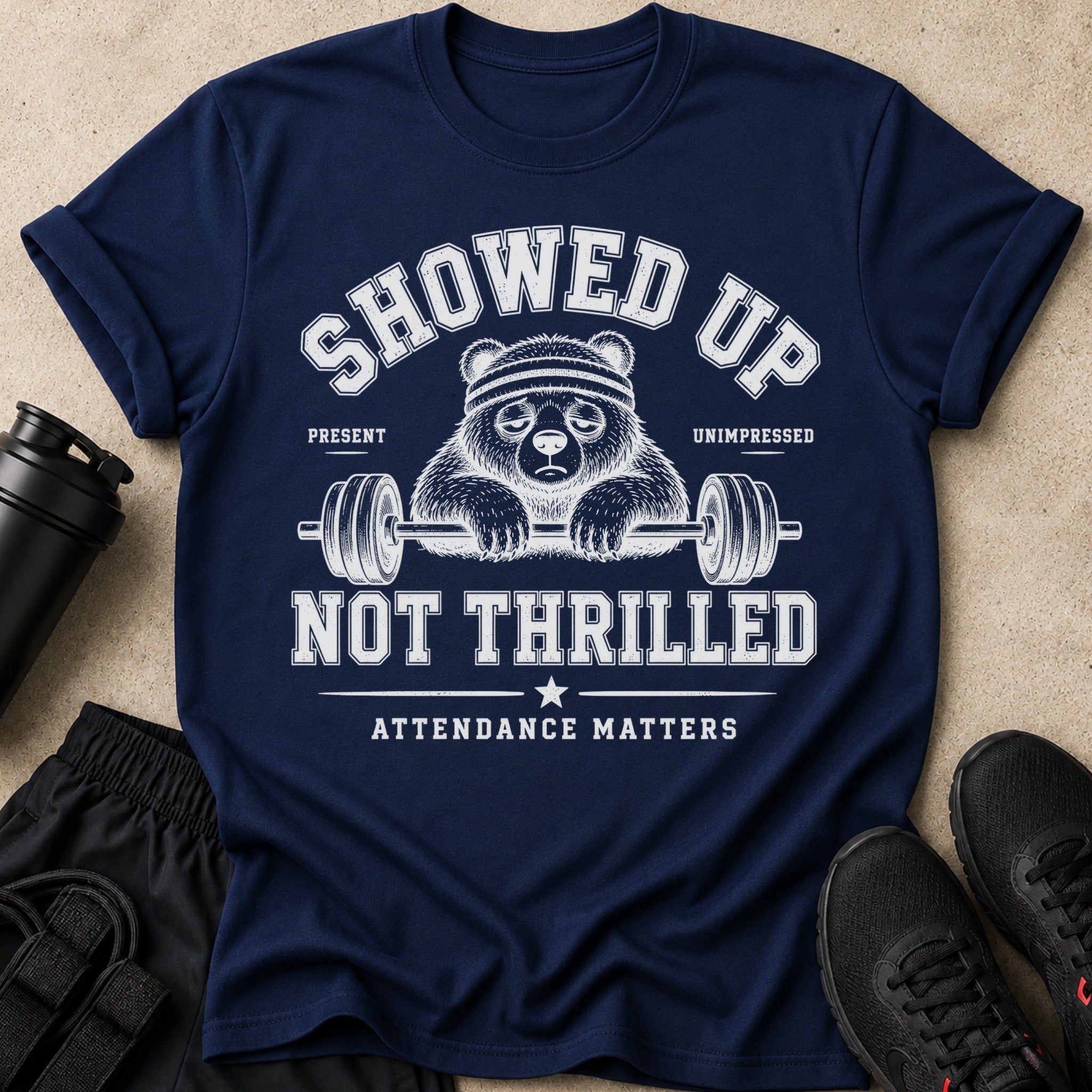 Navy t-shirt with graphic: "Showed Up, Not Thrilled, Attendance Matters."