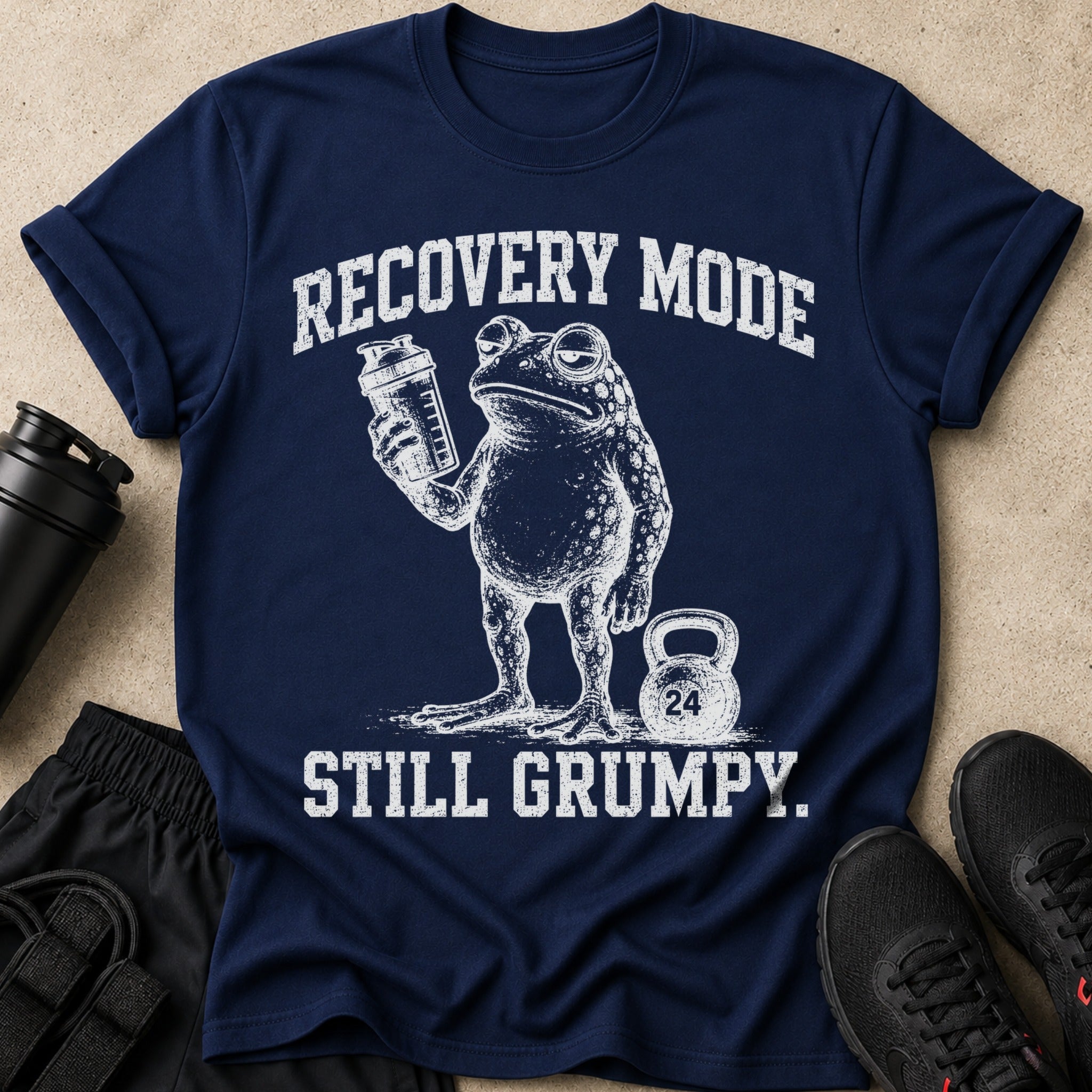 Navy t-shirt with white graphic of a frog holding a shaker and the text "RECOVERY MODE STILL GRUMPY."