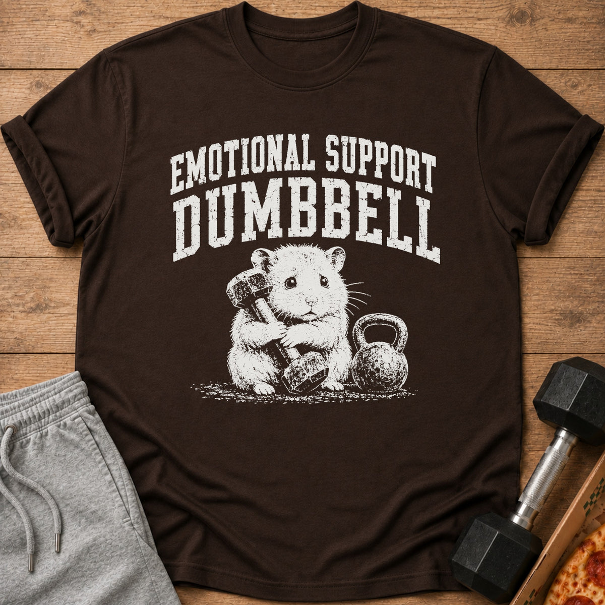 Brown t-shirt with text "EMOTIONAL SUPPORT DUMBBELL" and a hamster holding a dumbbell.