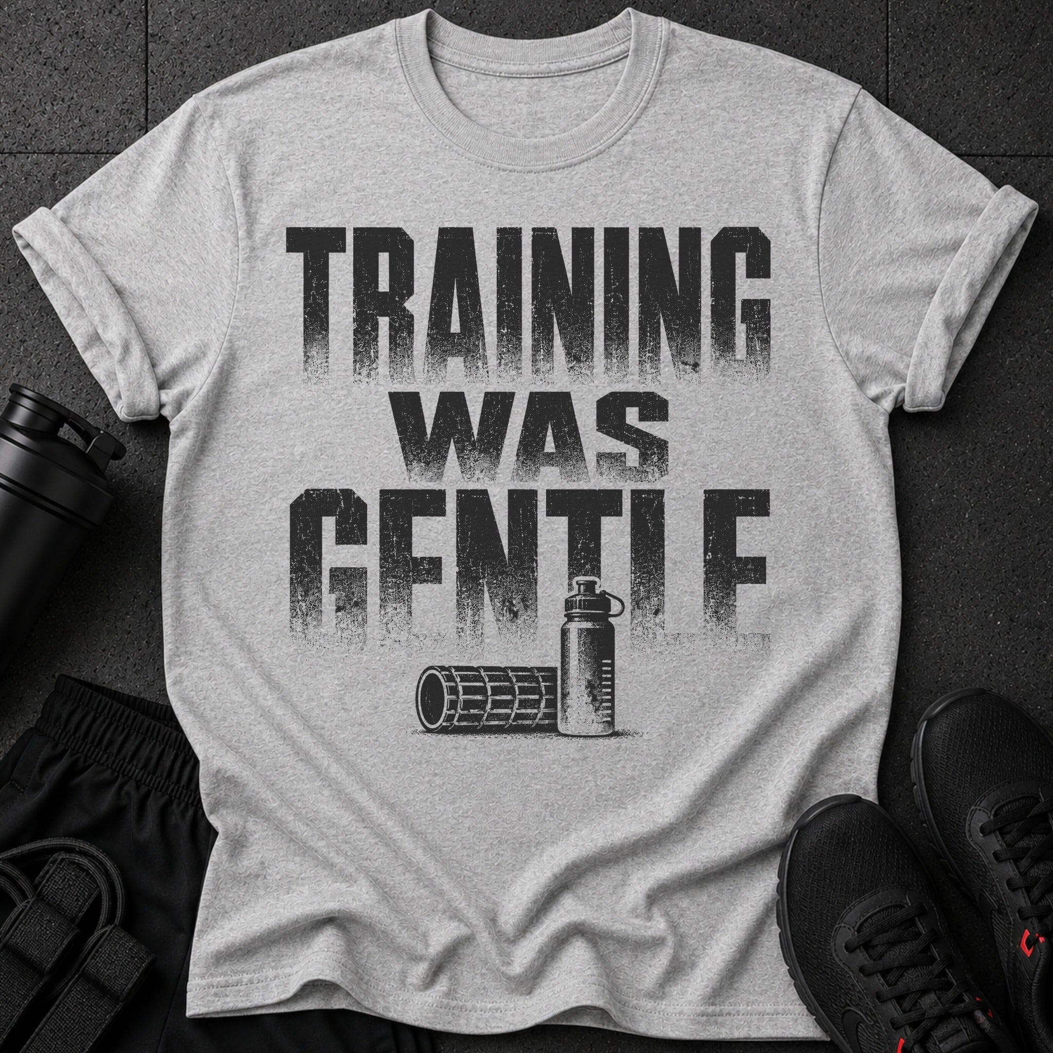 Gray t-shirt with distressed text "TRAINING WAS GENTLE" and graphics of fitness equipment.
