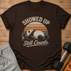Brown t-shirt with a panda, shaker bottle, and text "Showed Up Still Counts."