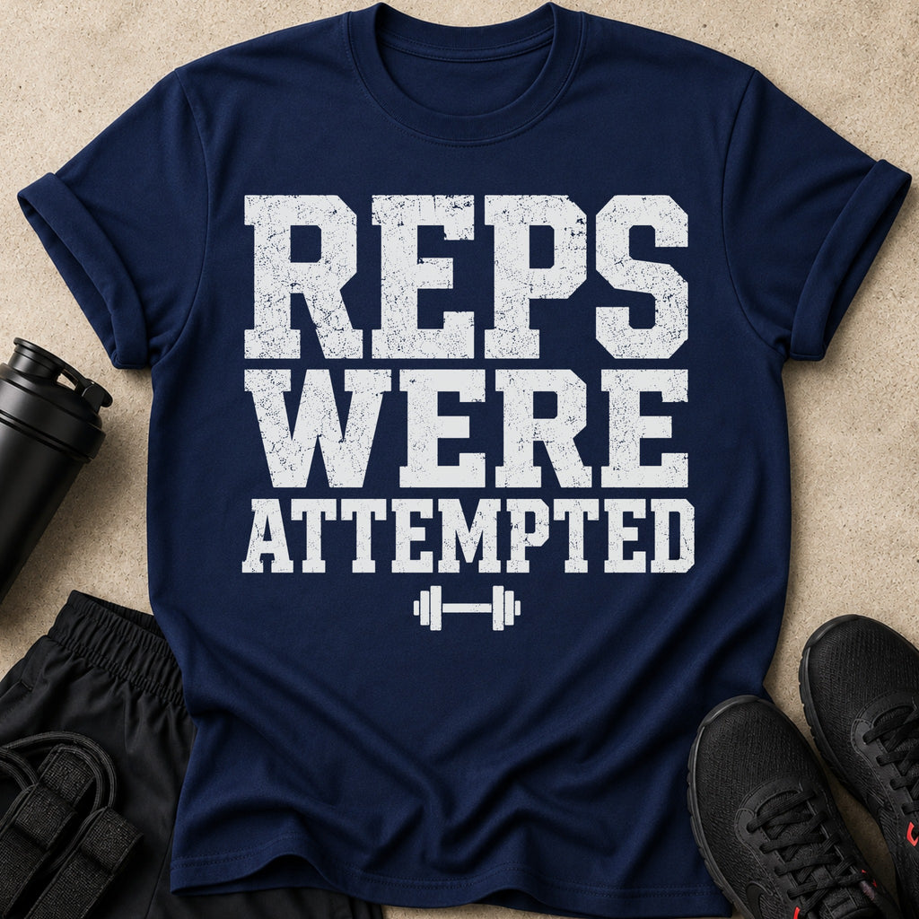 Navy t-shirt with white distressed text reading "REPS WERE ATTEMPTED" and a dumbbell graphic.