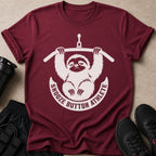 Maroon t-shirt with a white graphic of a sloth lifting weights and text "SNOOZE BUTTON ATHLETE".