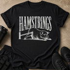 Black t-shirt with "HAMSTRINGS" text above a distressed illustration of a pig exercising