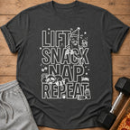 Dark grey t-shirt with white text: Lift Snack Nap Repeat, and cartoon graphics.