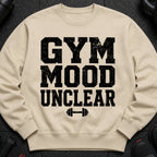Light beige sweatshirt with black distressed text: "GYM MOOD UNCLEAR" and a dumbbell icon.