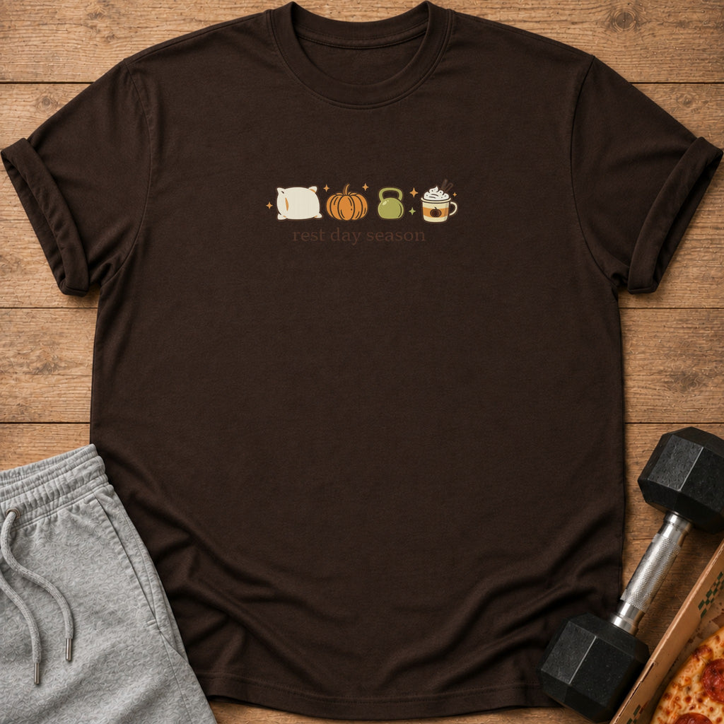 Brown t-shirt with pillow, pumpkin, kettlebell, and latte icons above text "rest day season".