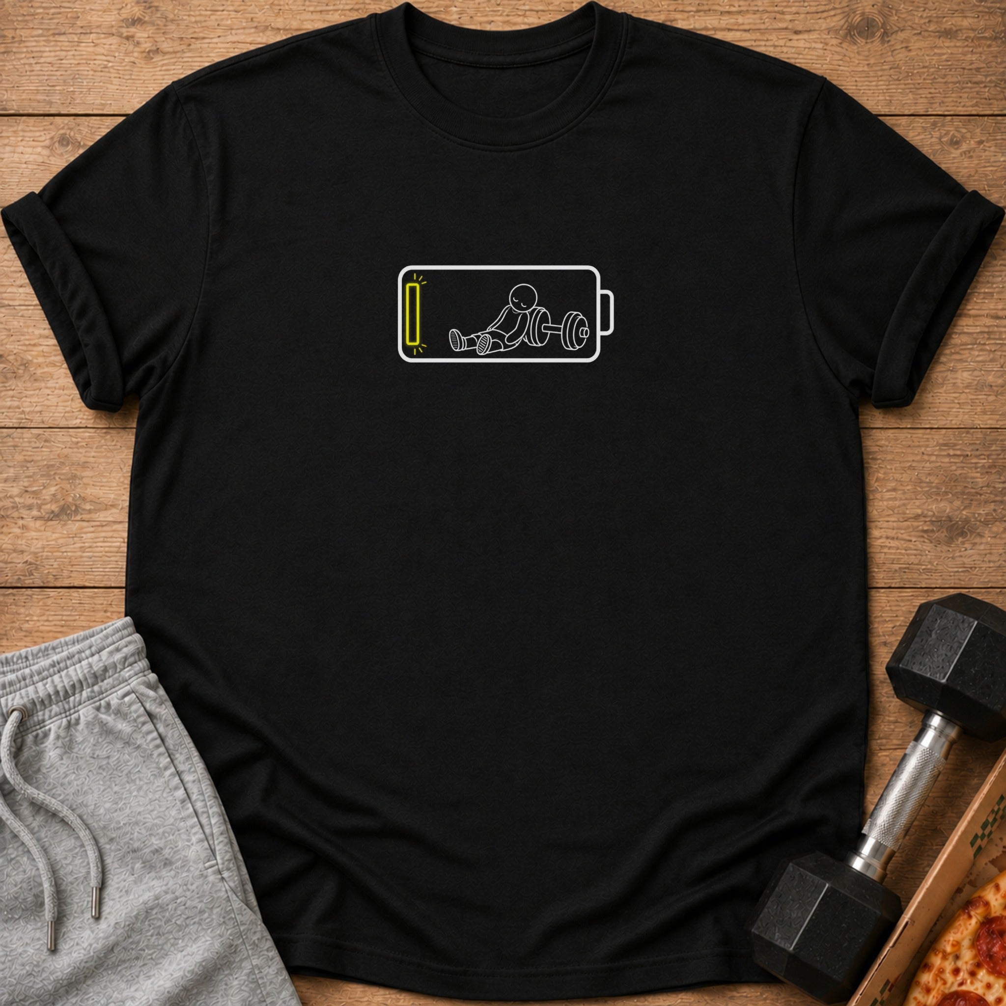 Black t-shirt with a white graphic of a stick figure with a barbell inside a low battery symbol.