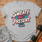 Grey t-shirt with "Sweaty But Present" text and fitness and pizza props.