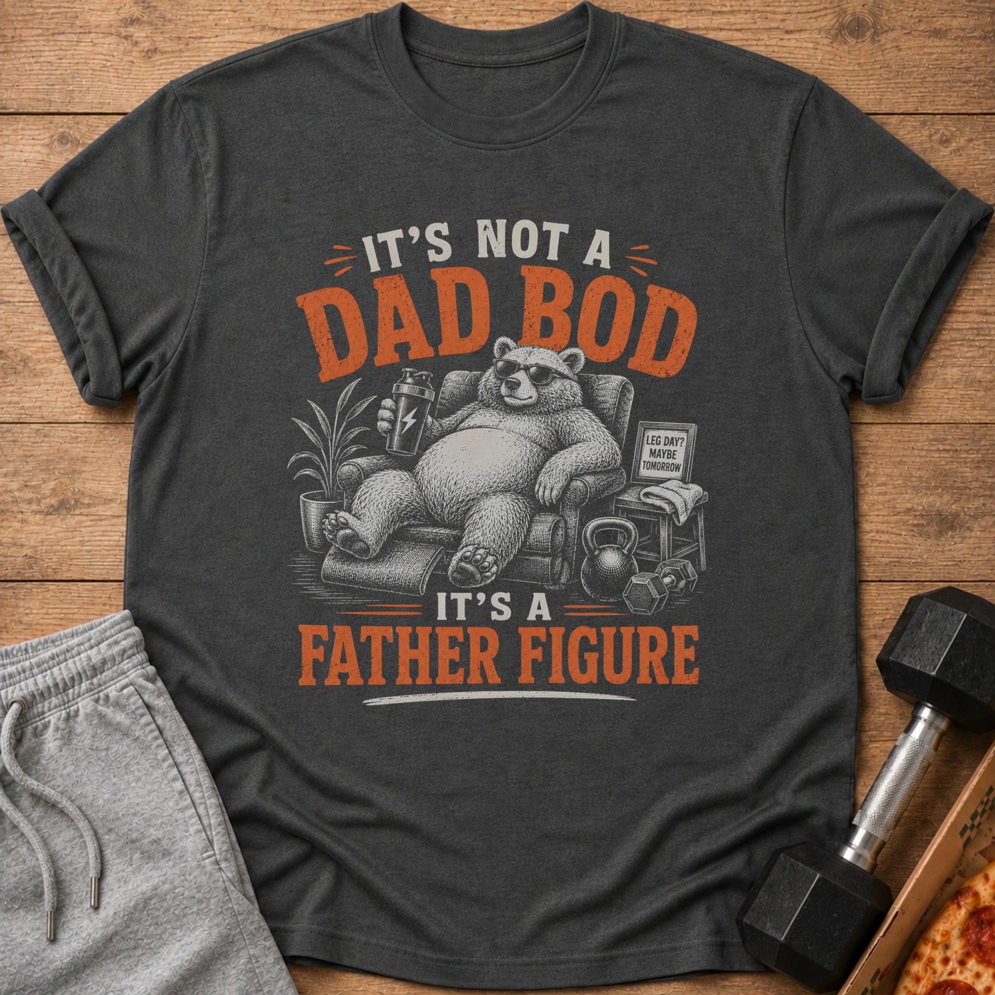 Dark gray t-shirt with "It's Not a Dad Bod, It's a Father Figure" text and bear graphic.