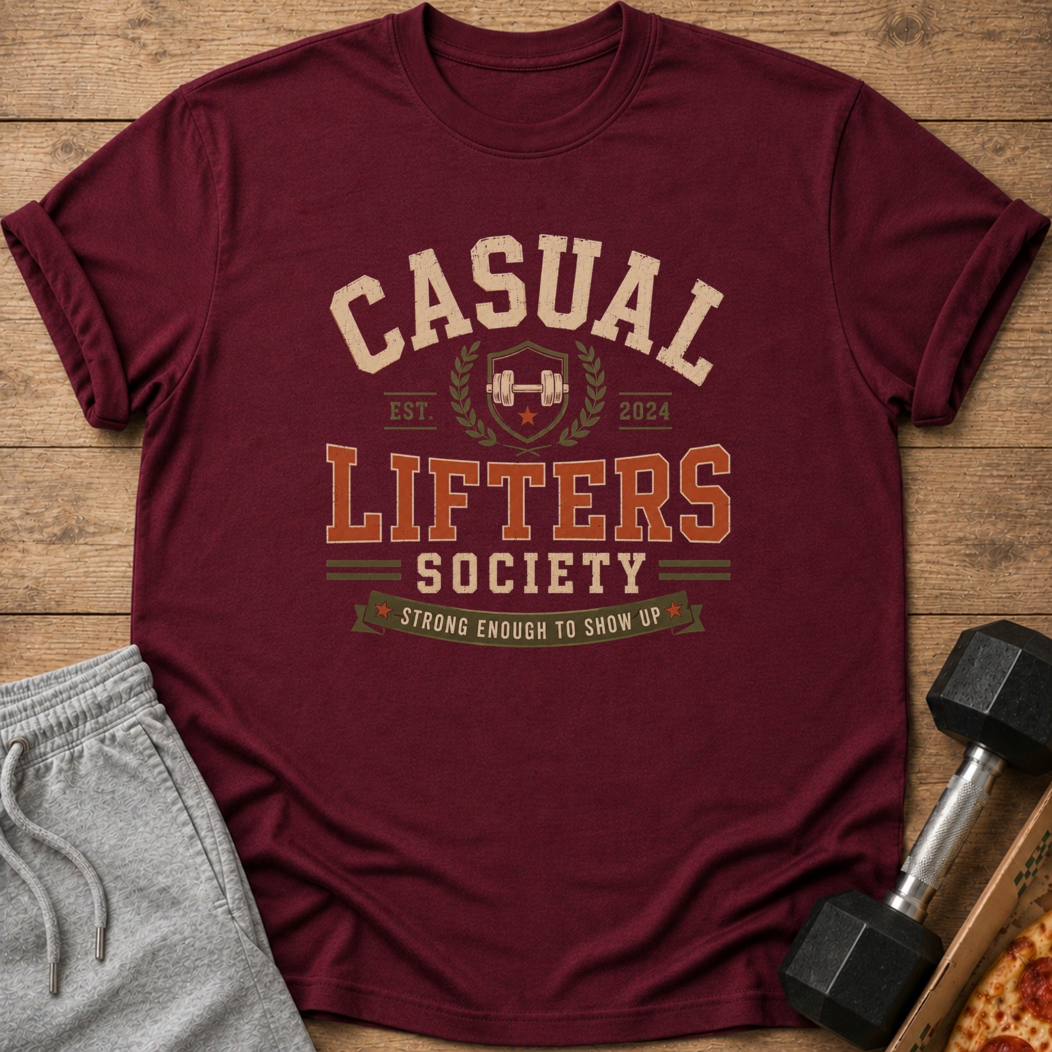 Maroon t-shirt with "Casual Lifters Society" text, barbell, and "Strong Enough To Show Up."