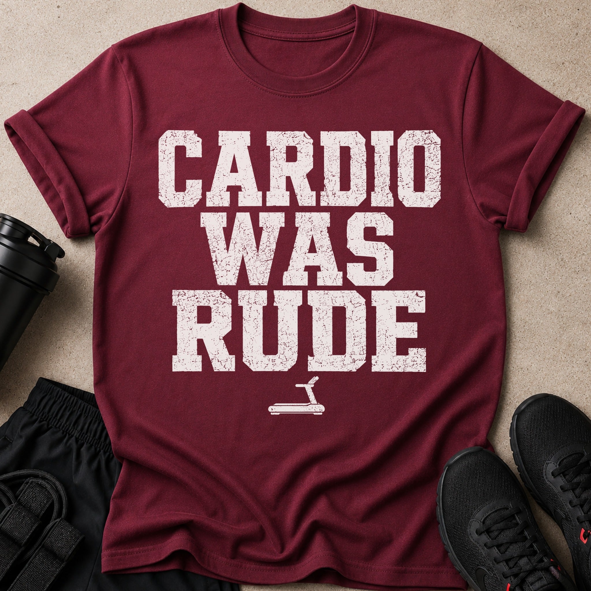 Maroon t-shirt with white distressed text "CARDIO WAS RUDE" and treadmill graphic.