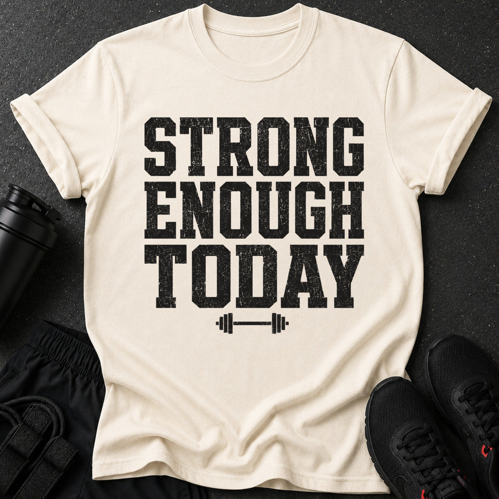 Cream t-shirt with distressed black text reading "STRONG ENOUGH TODAY" and a barbell graphic.