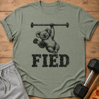 T-shirt with a smiling koala hanging from a barbell and lifting weights, with "FIED" text below.