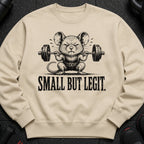 Cream sweatshirt with a distressed illustration of a mouse lifting a barbell. Text says "SMALL BUT LEGIT."