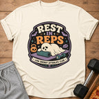 Ghost sleeping on yoga mat with dumbbell and text "REST IN REPS LOW ENERGY AFTERLIFE CLUB".