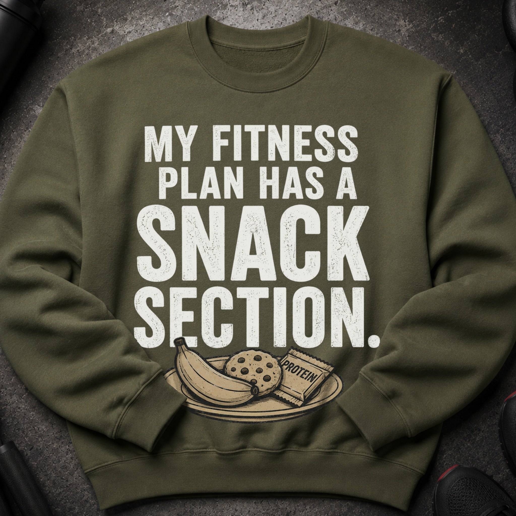 Olive green sweatshirt with white text about fitness and snacks.