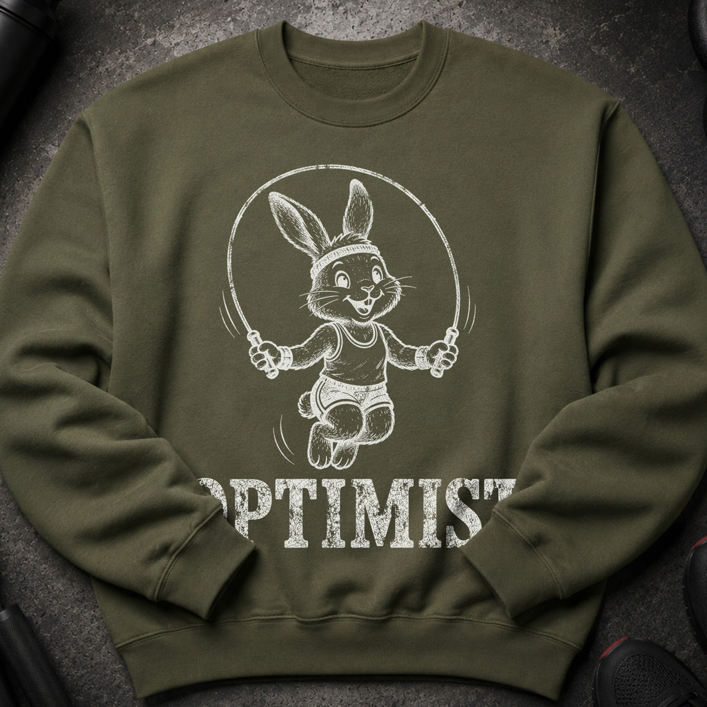 Olive green sweatshirt with a jumping cartoon rabbit and the word OPTIMIST.