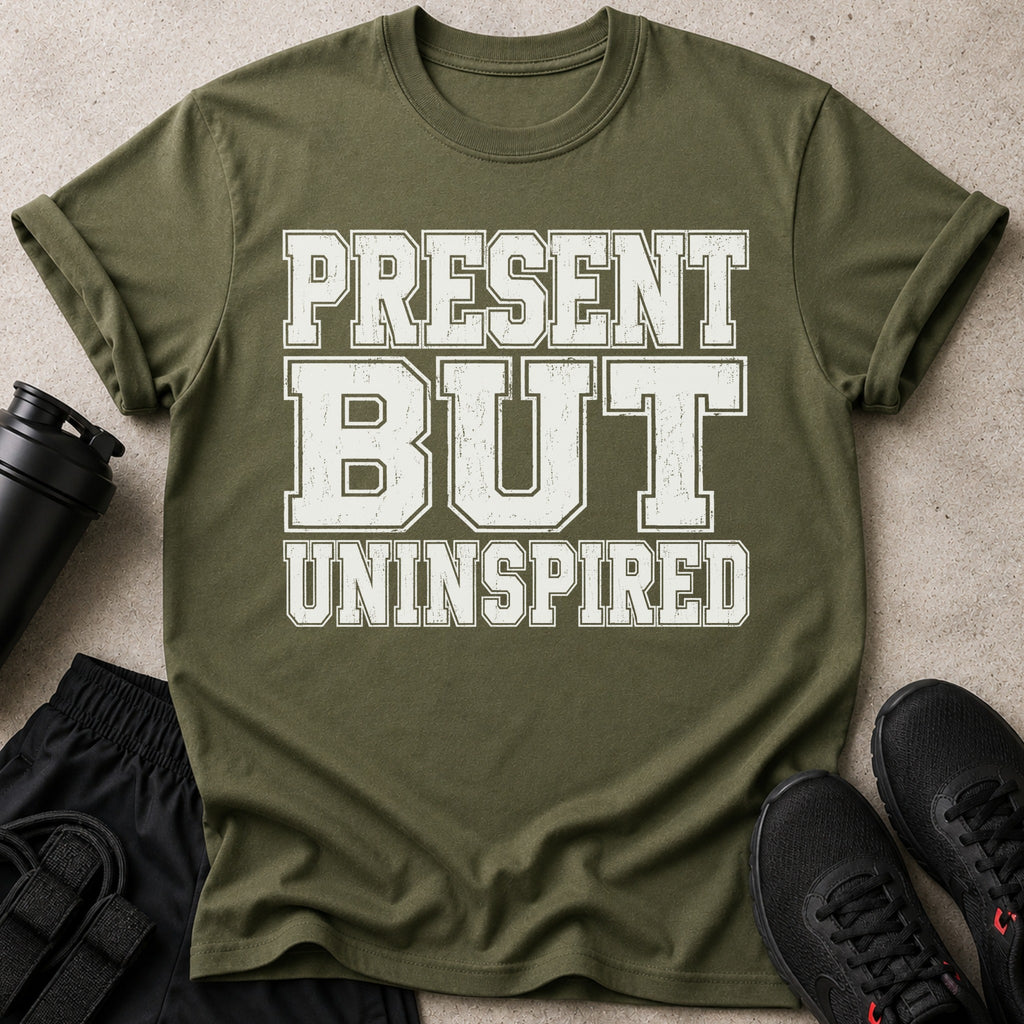 Olive green t-shirt with white distressed text reading "PRESENT BUT UNINSPIRED".