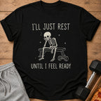 Black t-shirt with skeleton resting on bench, text "I'LL JUST REST UNTIL I FEEL READY".