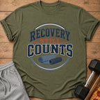 Green t-shirt with "Recovery Still Counts" text and yoga mat graphic.