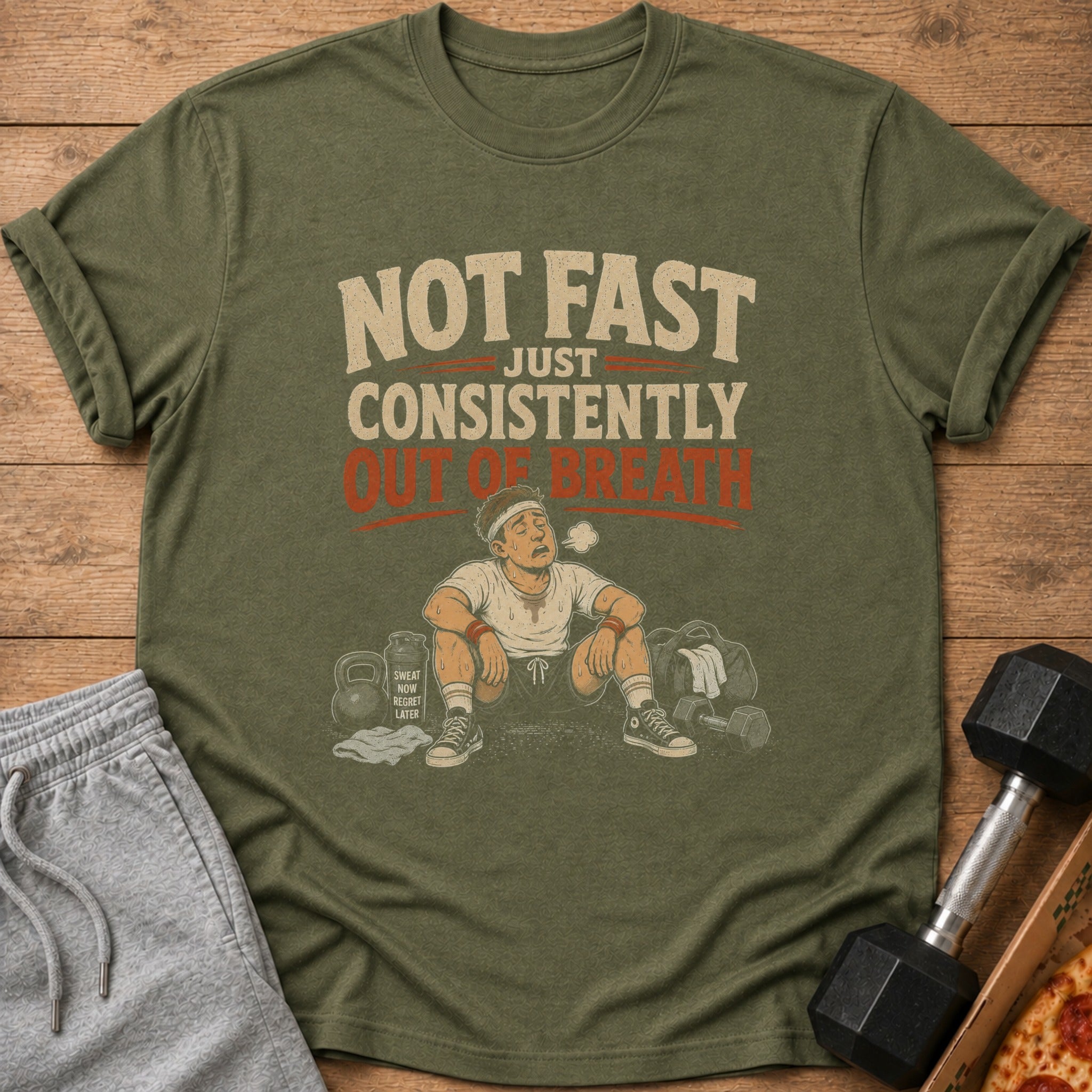 T-shirt with text "NOT FAST JUST CONSISTENTLY OUT OF BREATH" and gym graphics.