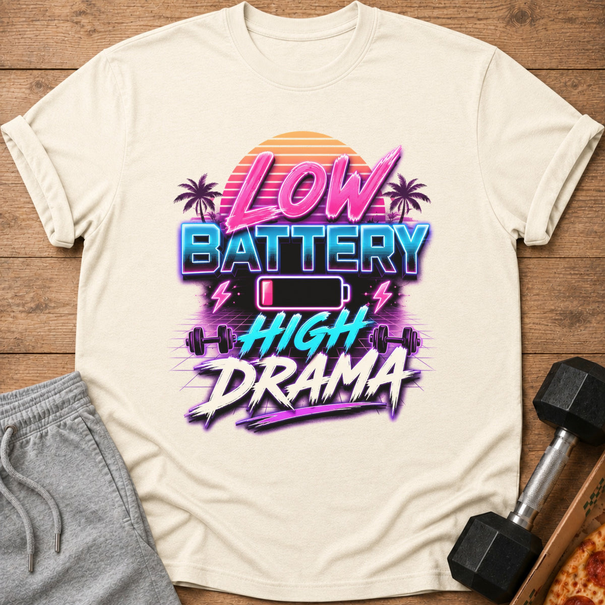 Cream t-shirt with "Low Battery High Drama" graphic and retro sunset design.
