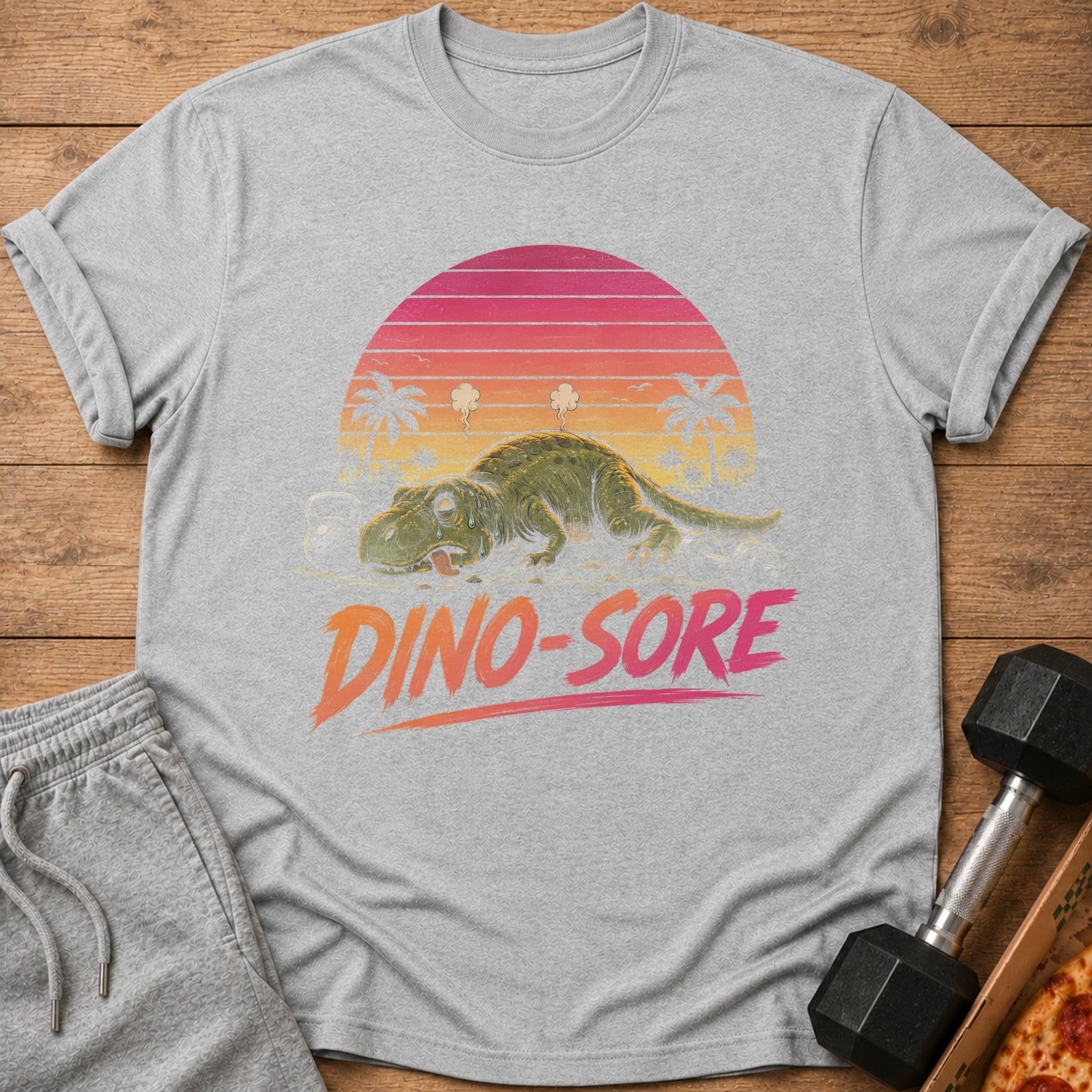 Grey t-shirt with a distressed graphic of a tired dinosaur and text "DINO-SORE".