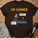 Brown t-shirt with pixel art saying "XP GAINED" and a gym scene.