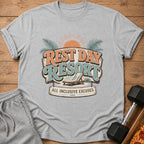 Gray t-shirt with "Rest Day Resort All Inclusive Excuses" graphic and beach chair.