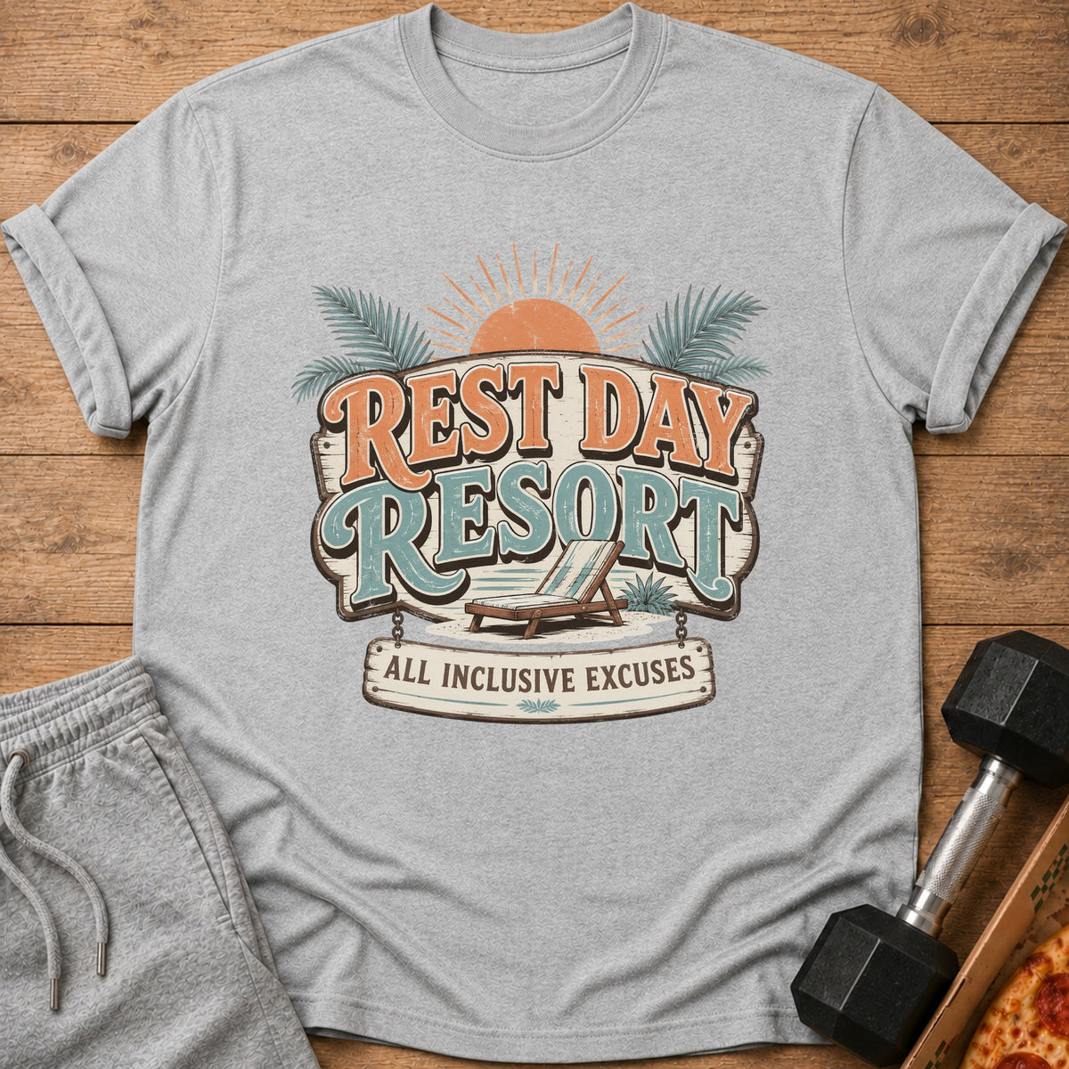 Gray t-shirt with "Rest Day Resort All Inclusive Excuses" graphic and beach chair.